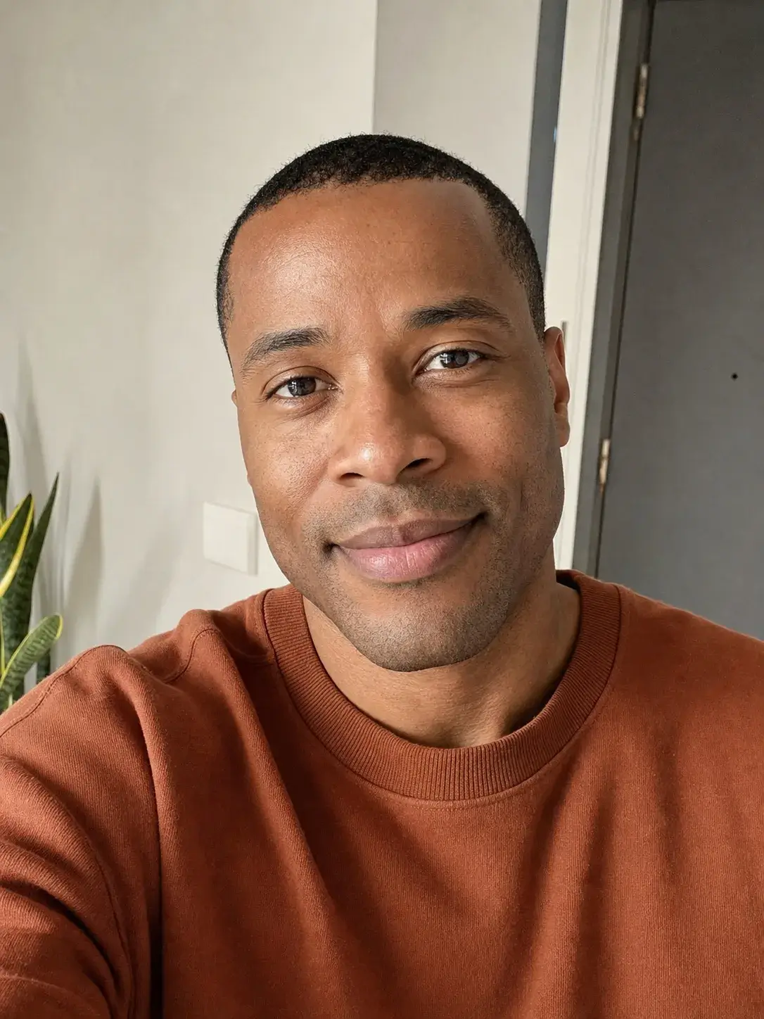 AI-generated synthetic sample portrait of an adult man in an everyday indoor selfie